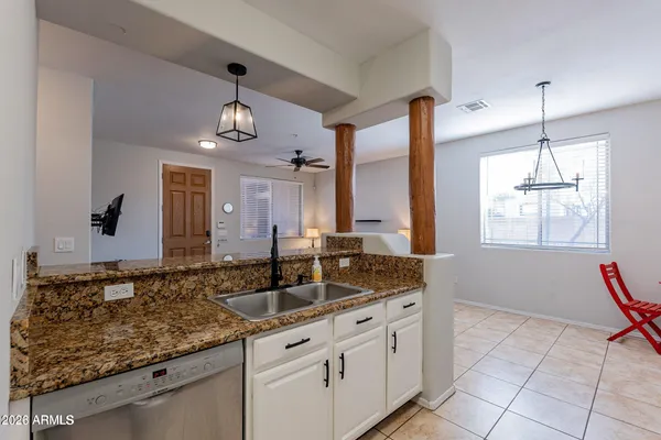 a bathroom with a granite countertop sink and a large mirror