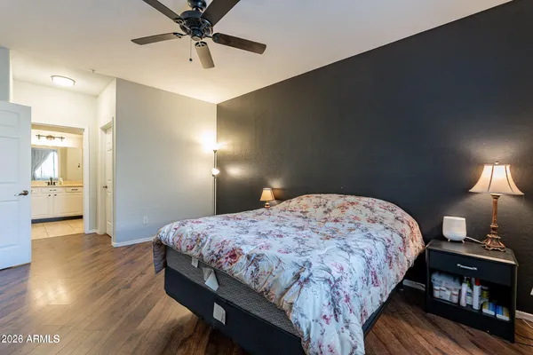 a bedroom with a bed and wooden floor