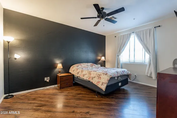 a bedroom with a bed and a large window