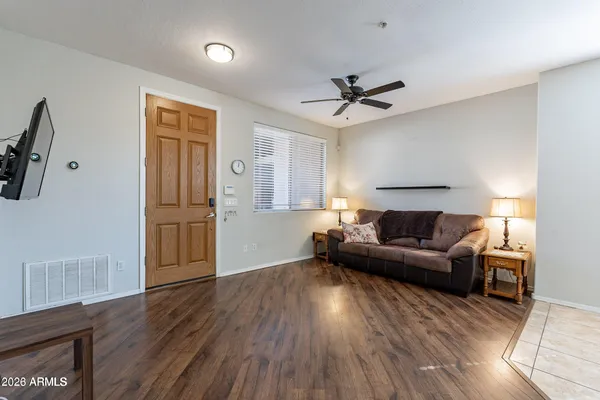 a living room with furniture and a wooden floor