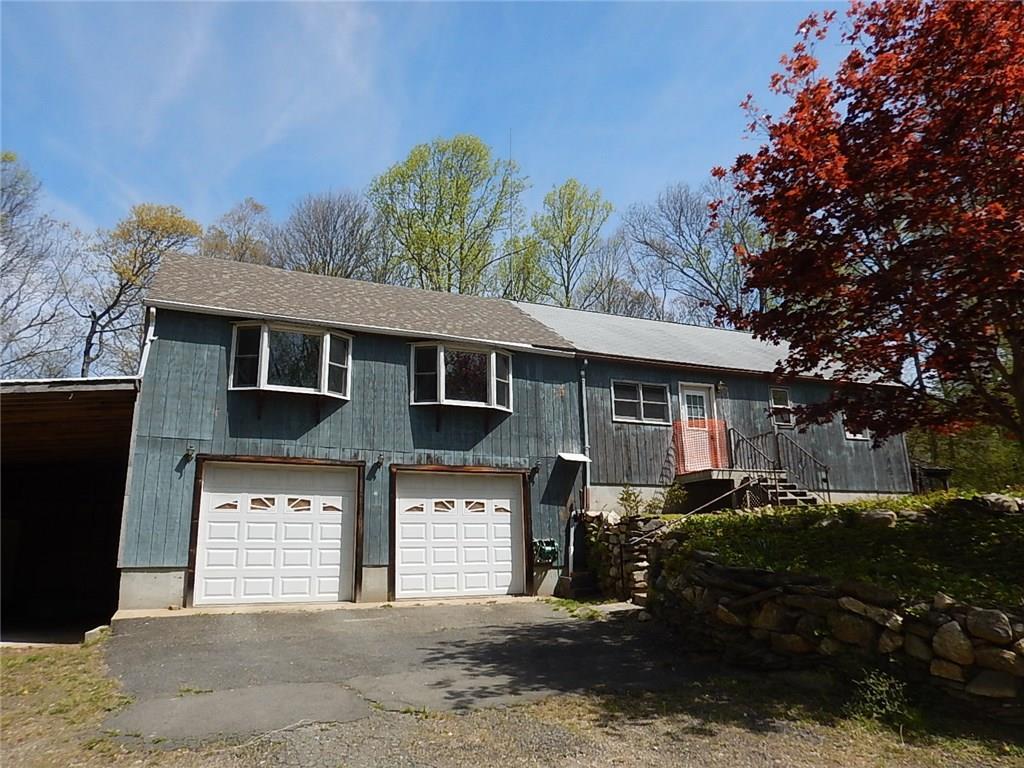 752 Old Clinton Road Westbrook, CT 06498 - Photo 1 of 1 a front view of a house with a yard and garage