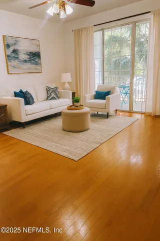 a living room with a rug and a window