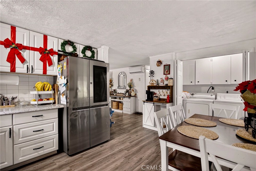 3156 Esplanade, Unit 292 Chico, CA 95973 - Photo 18 of 44 a kitchen with stainless steel appliances kitchen island granite countertop a refrigerator and cabinets