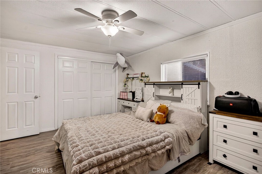 3156 Esplanade, Unit 292 Chico, CA 95973 - Photo 20 of 44 a bedroom with a bed and wooden floor