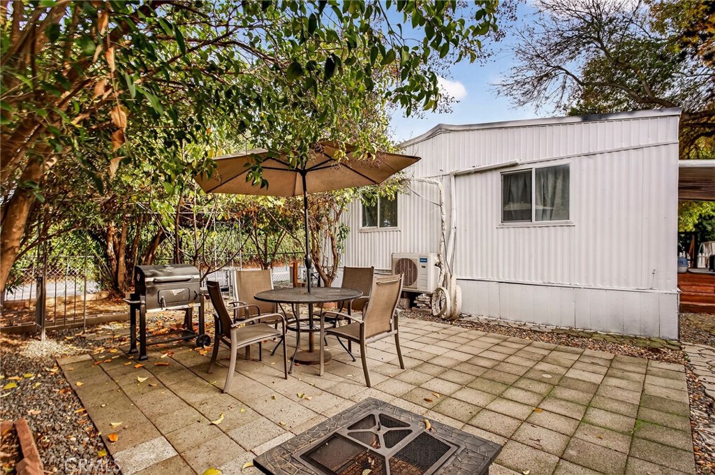 3156 Esplanade, Unit 292 Chico, CA 95973 - Photo 37 of 44 a view of a patio with table and chairs under an umbrella