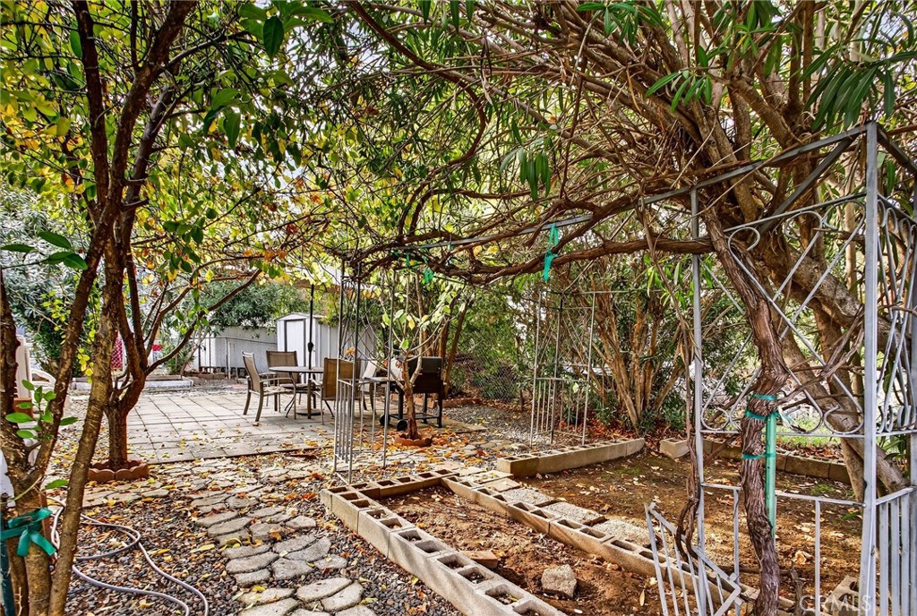 3156 Esplanade, Unit 292 Chico, CA 95973 - Photo 40 of 44 a wooden bench with trees in the background