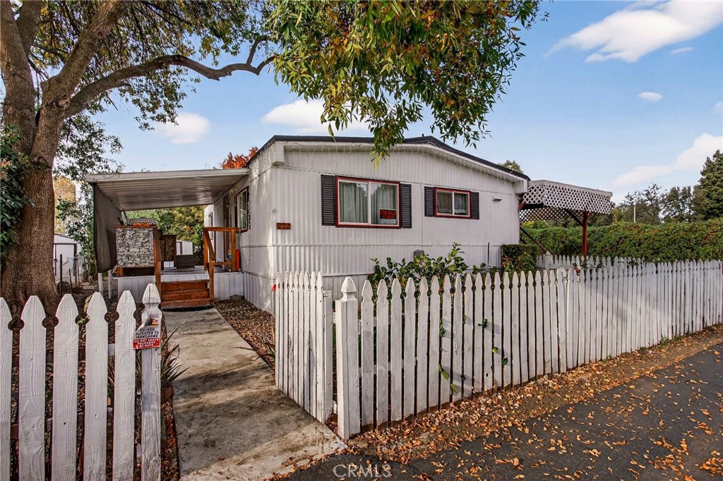 3156 Esplanade, Unit 292 Chico, CA 95973 - Photo 5 of 44 a front view of white house with a small yard