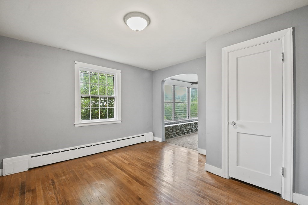 40 New Boston Road Sturbridge, MA 01566 - Photo 12 of 36 an empty room with wooden floor and windows