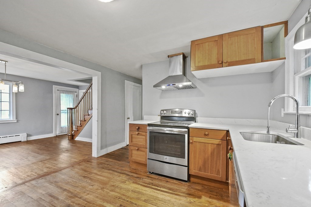 40 New Boston Road Sturbridge, MA 01566 - Photo 5 of 36 a kitchen with stainless steel appliances a stove a sink and a refrigerator