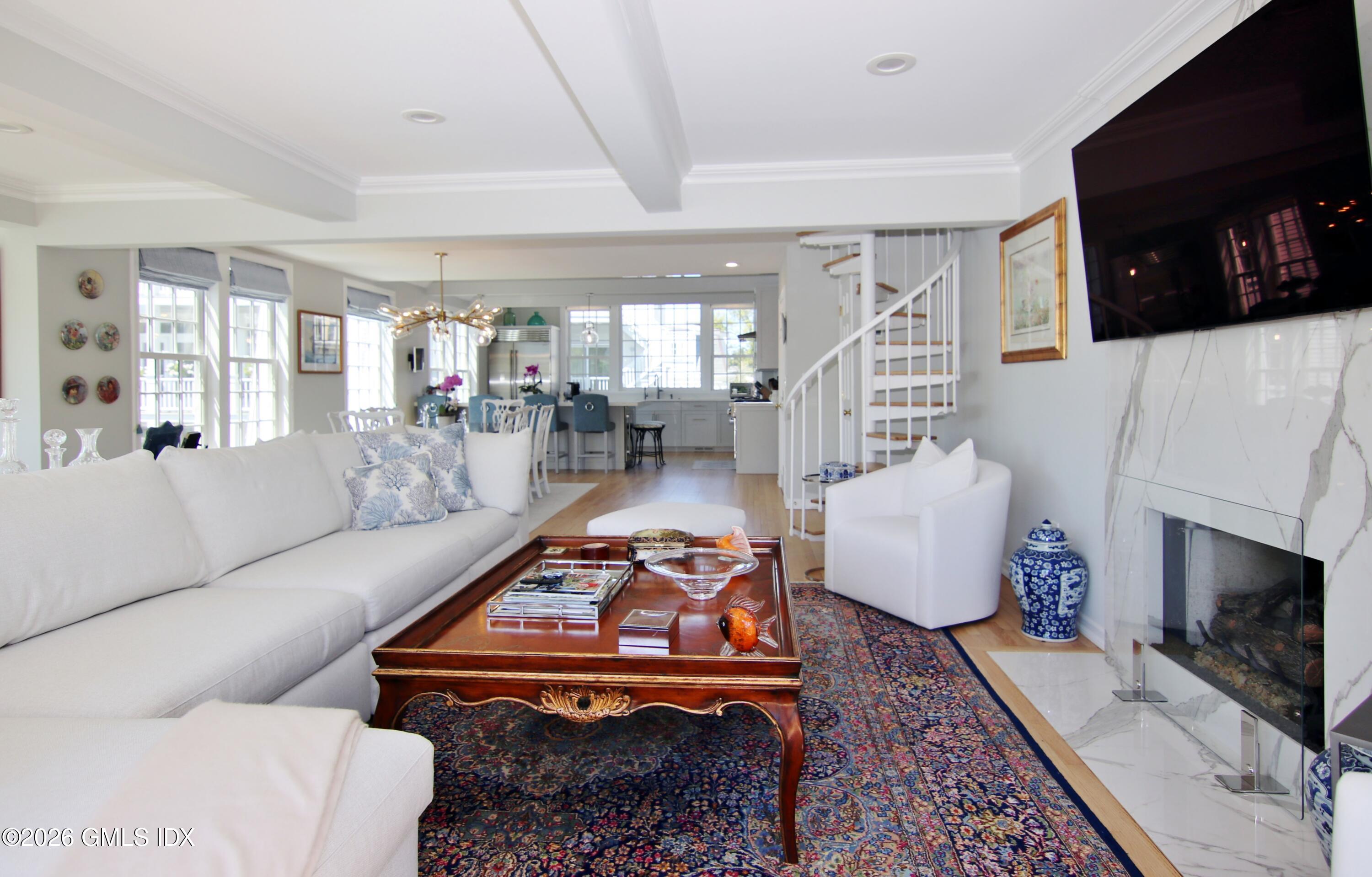 633 Steamboat Road, Unit 5 Greenwich, CT 06830 - Photo 21 of 29 a living room with furniture a flat screen tv and a fireplace