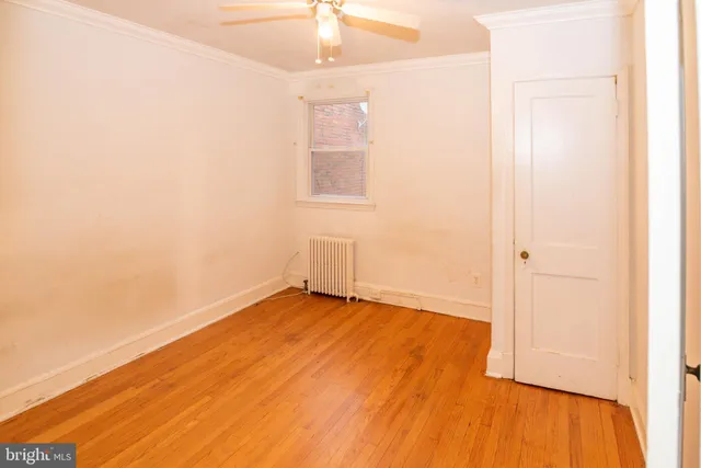 a view of a room with wooden floor