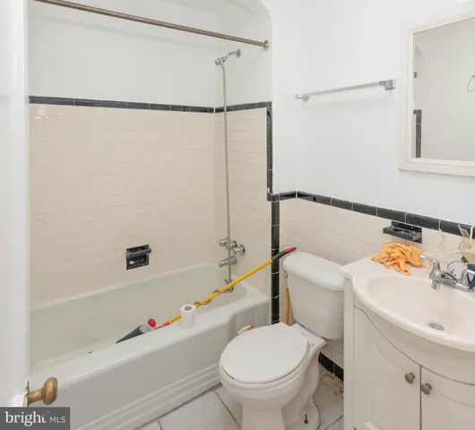 a white toilet sitting next to a bath tub