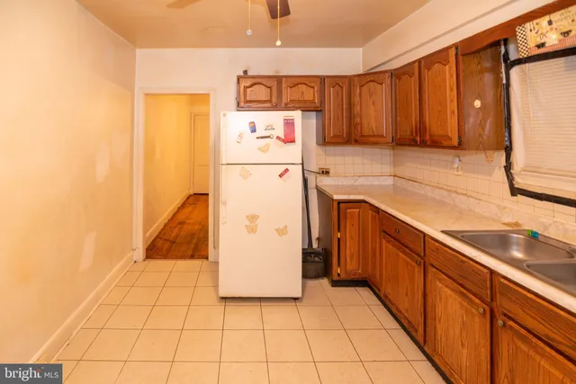 a kitchen with a refrigerator sink and cabinets