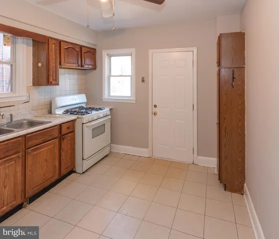 a kitchen with a stove a sink and a refrigerator