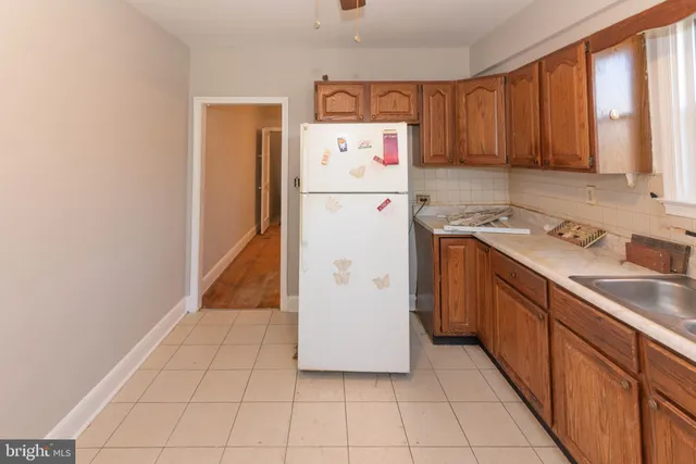 a kitchen with a cabinets and white appliances