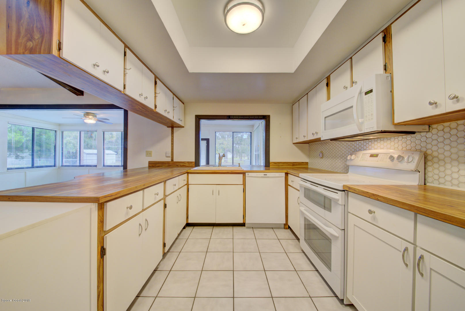 4660 Rector Road Cocoa, FL 32926 - Photo 10 of 56 kitchen with pass-thru to Florida room