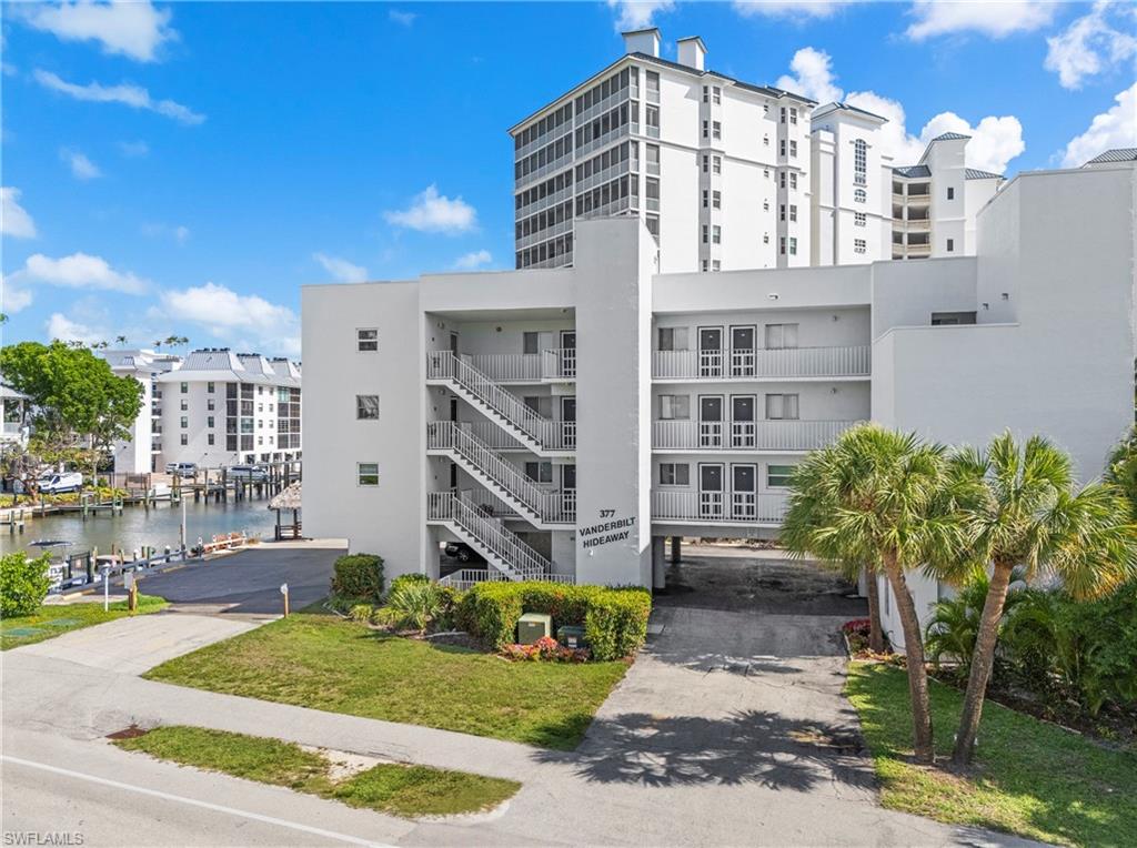 377 Vanderbilt Beach Road, Unit 102 Naples, FL 34108 - Photo 2 of 19 a front view of a building