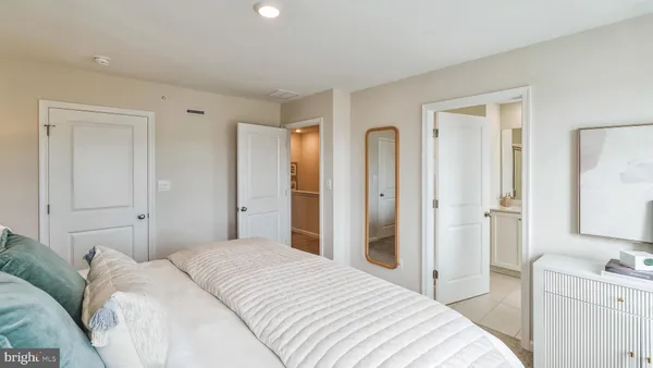 a bedroom with a bed and a lamp