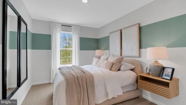 a bedroom with a bed wooden floor and window