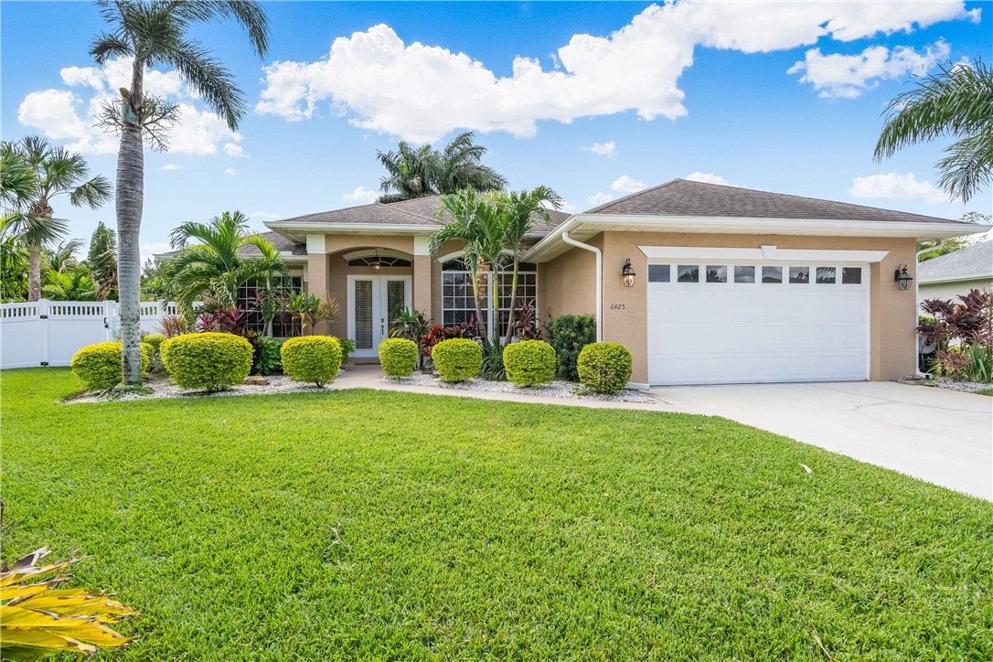 6425 33rd Lane Vero Beach, FL 32966 - Photo 2 of 29 a front view of a house with garden