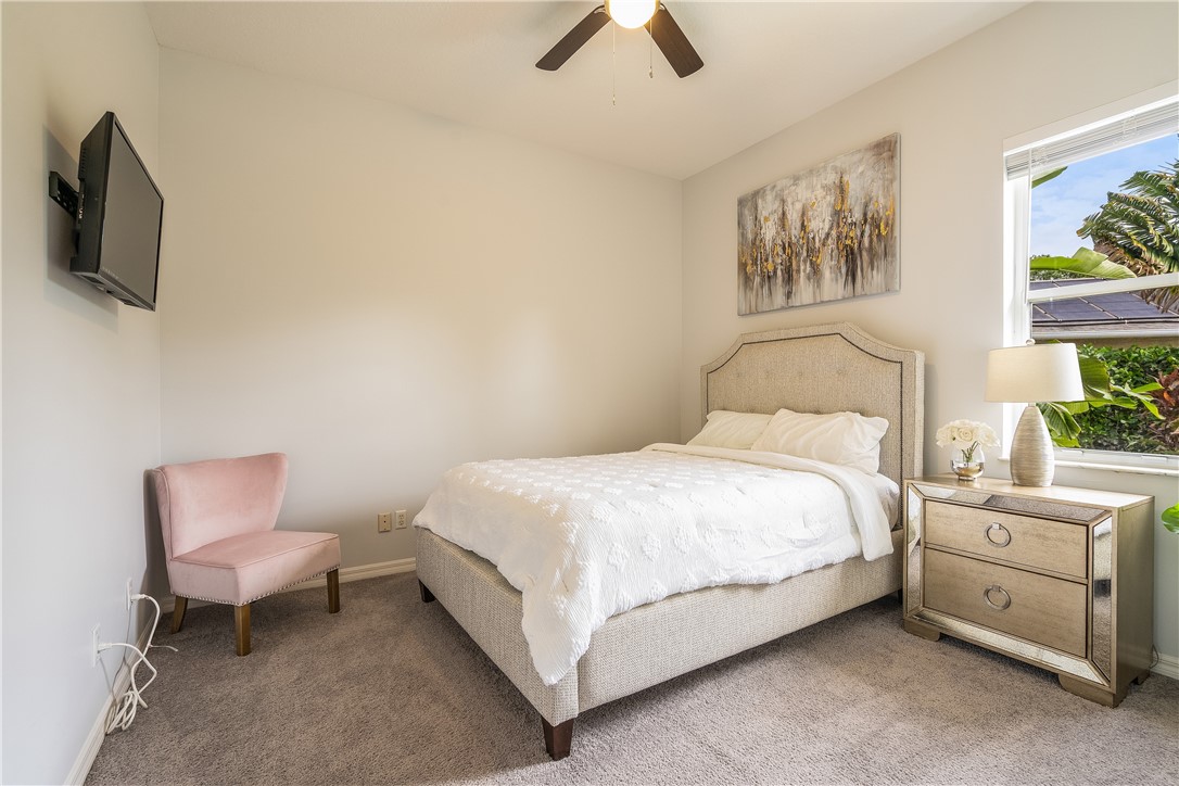 6425 33rd Lane Vero Beach, FL 32966 - Photo 21 of 29 a bedroom with a bed and a chair
