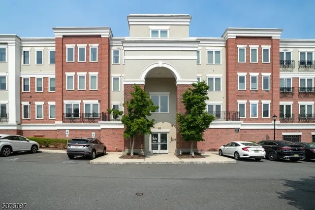 a couple of cars parked in front of a building