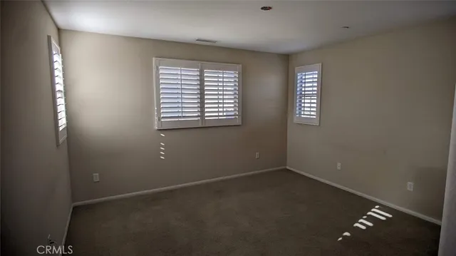 a bathroom with a granite countertop sink a toilet and a mirror