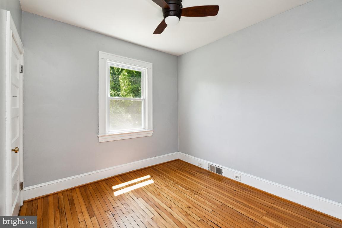 1813 Fairbank Road Baltimore, MD 21209 - Photo 29 of 65 First bedroom on first floor wood floors and fan