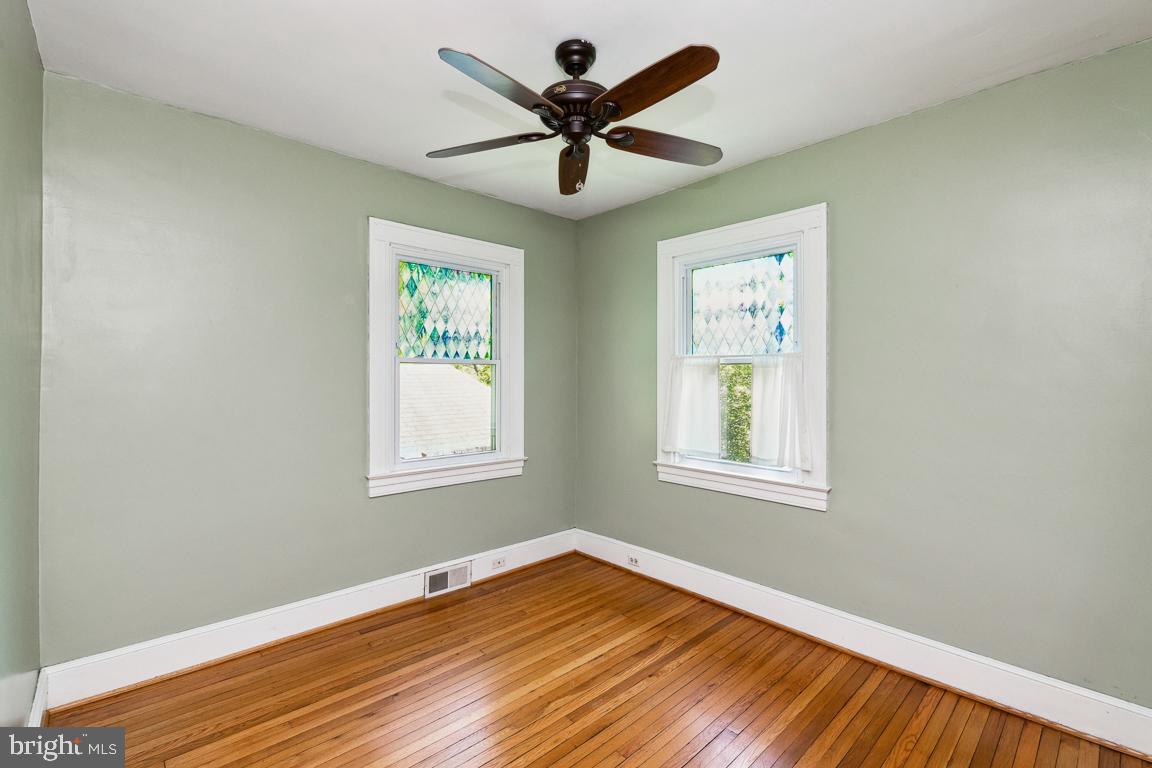 1813 Fairbank Road Baltimore, MD 21209 - Photo 31 of 65 Second bedroom on first floor wood floors and fan