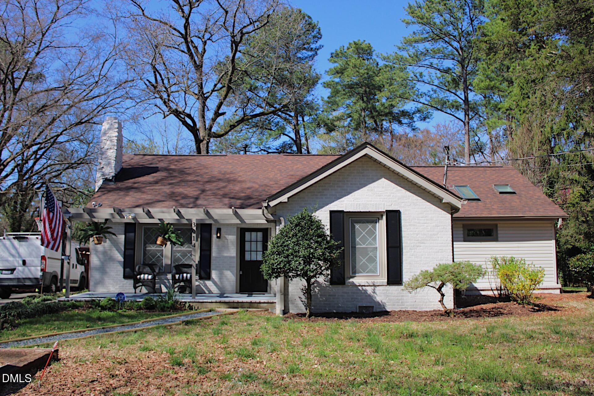 a view of a house with yard and sitting area