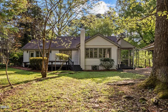 a view of a house with backyard porch and sitting area