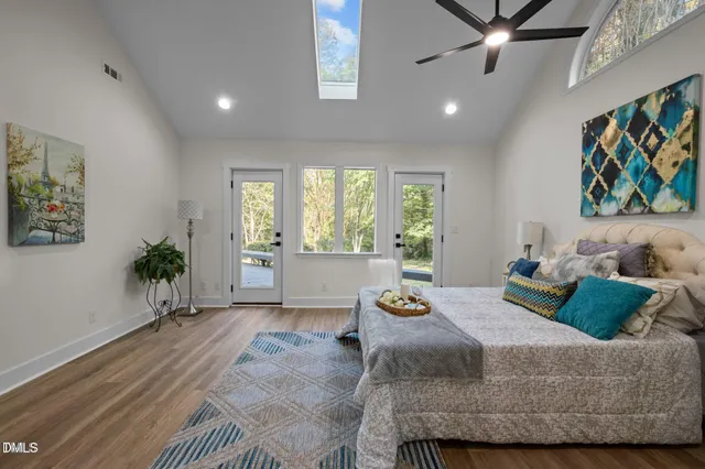 a bedroom with a bed and a painting on the wall