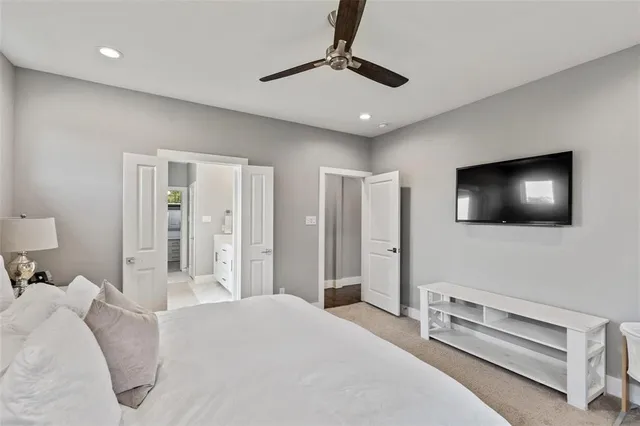 a bedroom with a large bed and a chandelier