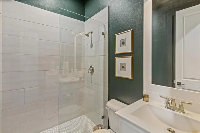 a bathroom with a sink toilet and shower