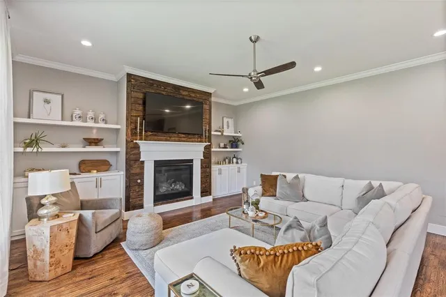 a dining room with furniture a chandelier and wooden floor