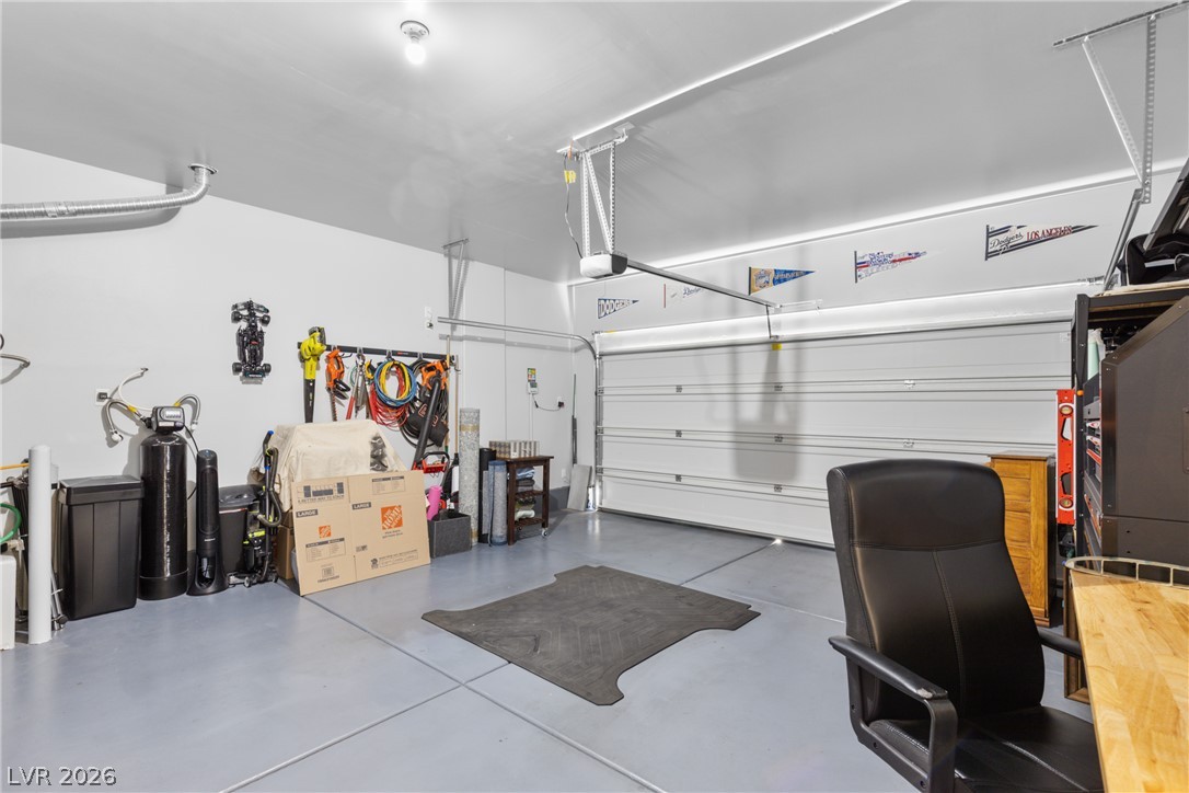 891 Earth Luster Road Las Vegas, NV 89178 - Photo 43 of 48 A pristine garage with a smooth concrete floor and convenient storage options.