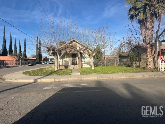 Undisclosed Address Wasco, CA 93280 - Photo 2 of 10 a front view of a house with a yard