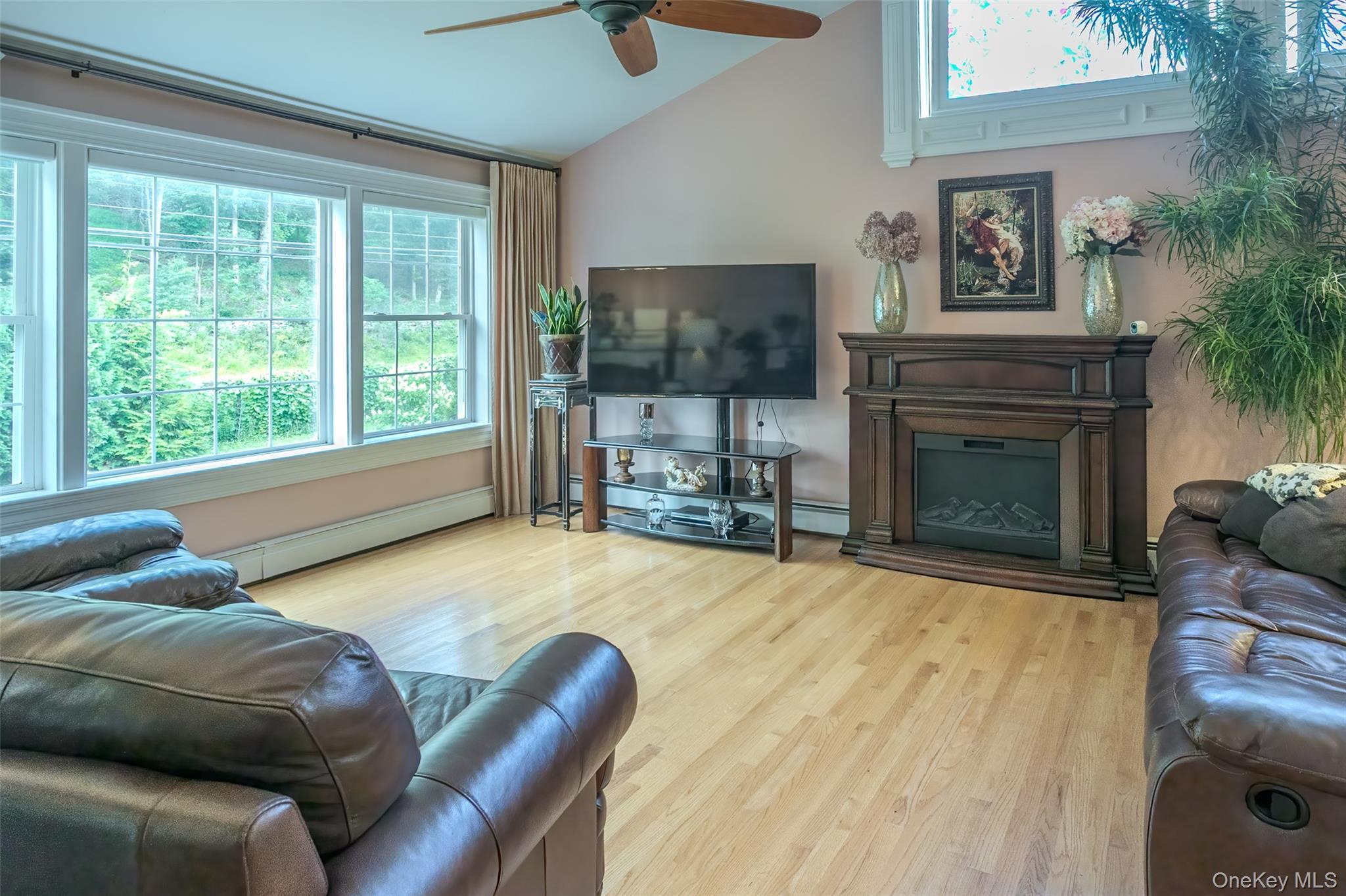 300 Mountain Lodge Road Monroe, NY 10950 - Photo 11 of 41 Living area featuring vaulted ceiling, a baseboard radiator, light wood-style flooring, and a ceiling fan