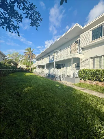 a view of house with yard and green space