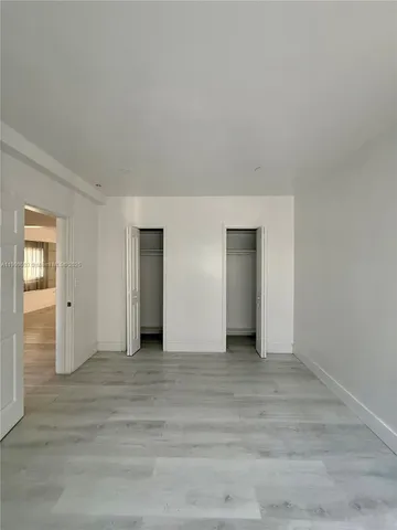 a view of an empty room with closet and closet