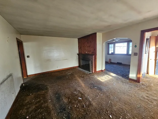 a view of empty room with a fireplace