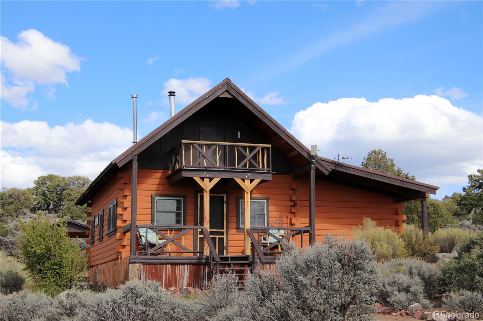 6132 Running Horse Road San Luis, CO 81152 - Photo 2 of 45 a front view of a house with garden