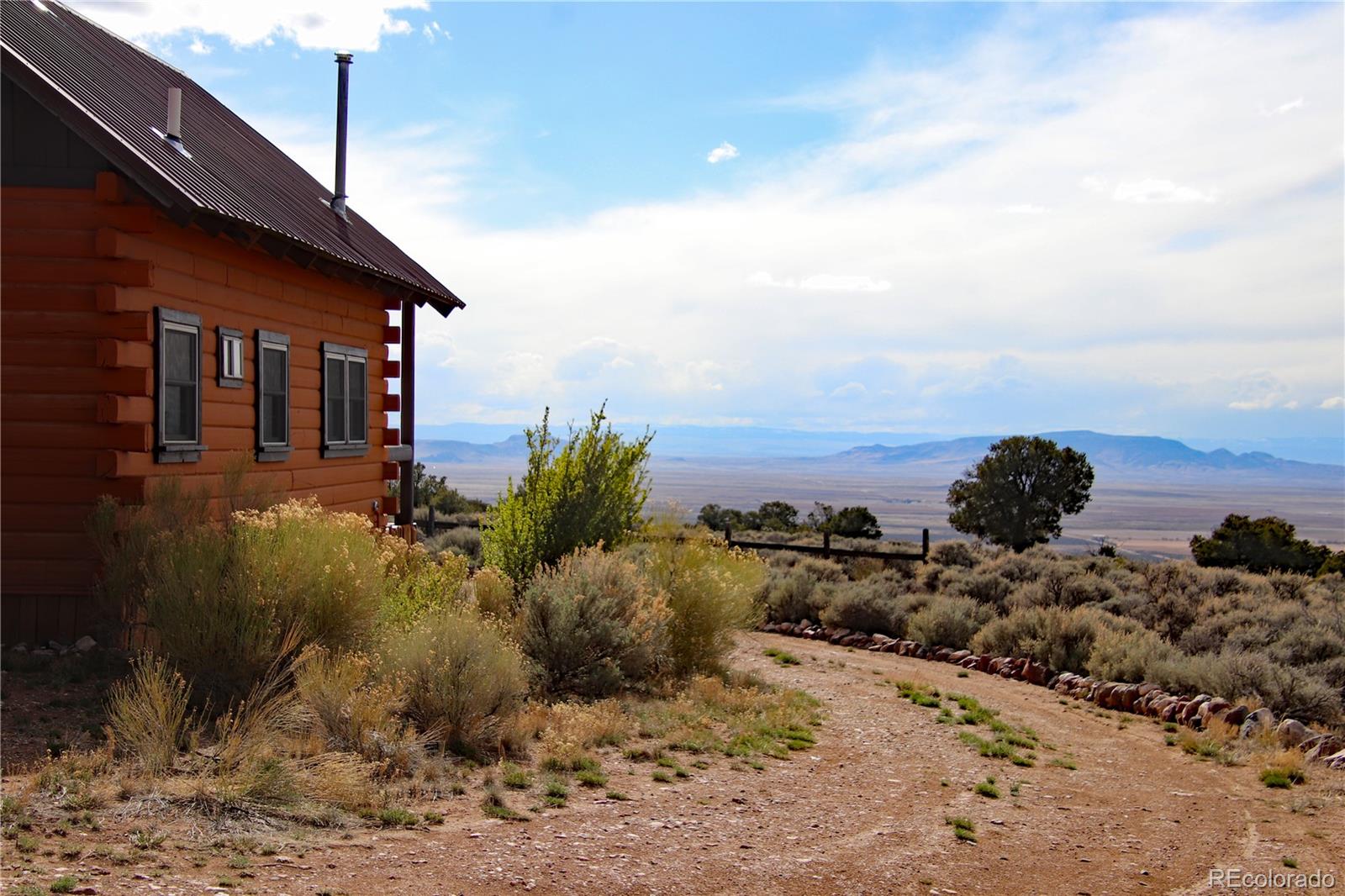 6132 Running Horse Road San Luis, CO 81152 - Photo 7 of 45 a view of a dry yard with wooden fence