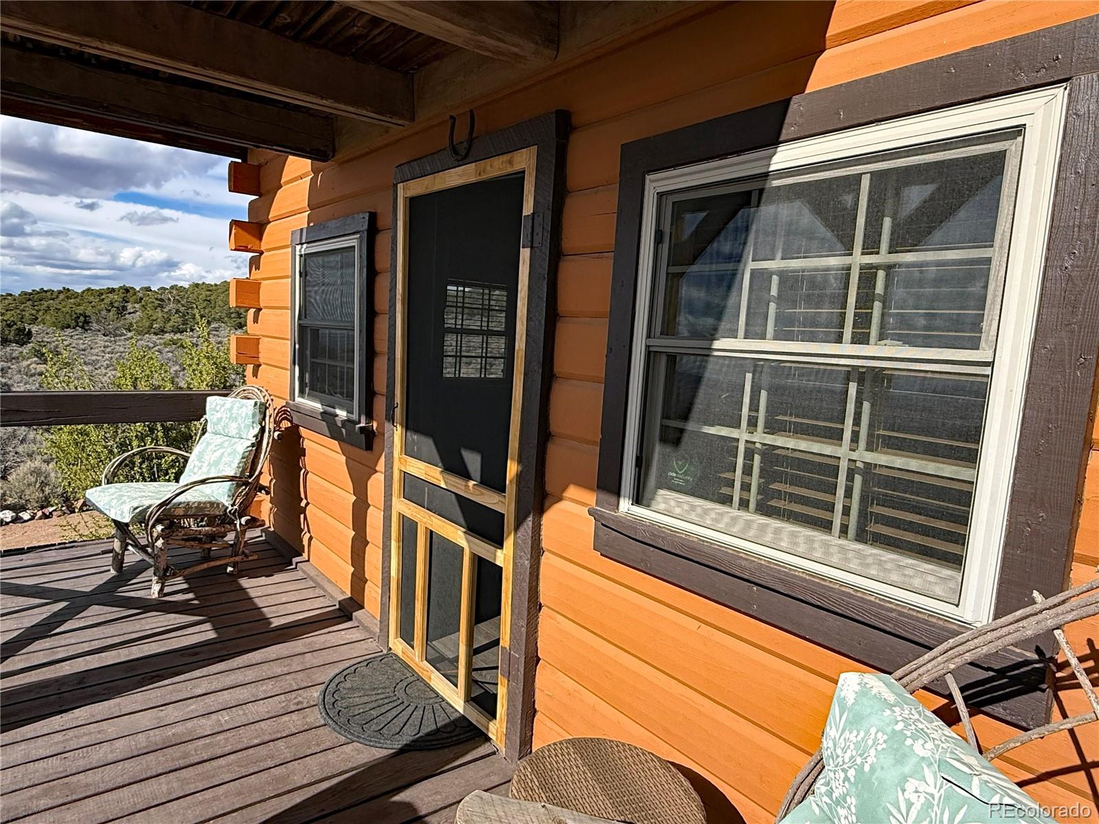 6132 Running Horse Road San Luis, CO 81152 - Photo 9 of 45 a view of a balcony with couch and wooden floor