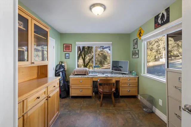 a view of a bedroom with a bed and wooden floor