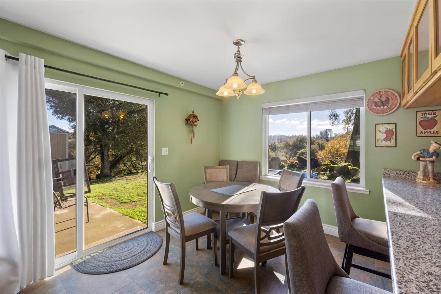 2870 Sand Ridge Road Placerville, CA 95667 - Photo 19 of 91 a dining room with furniture a chandelier and large windows