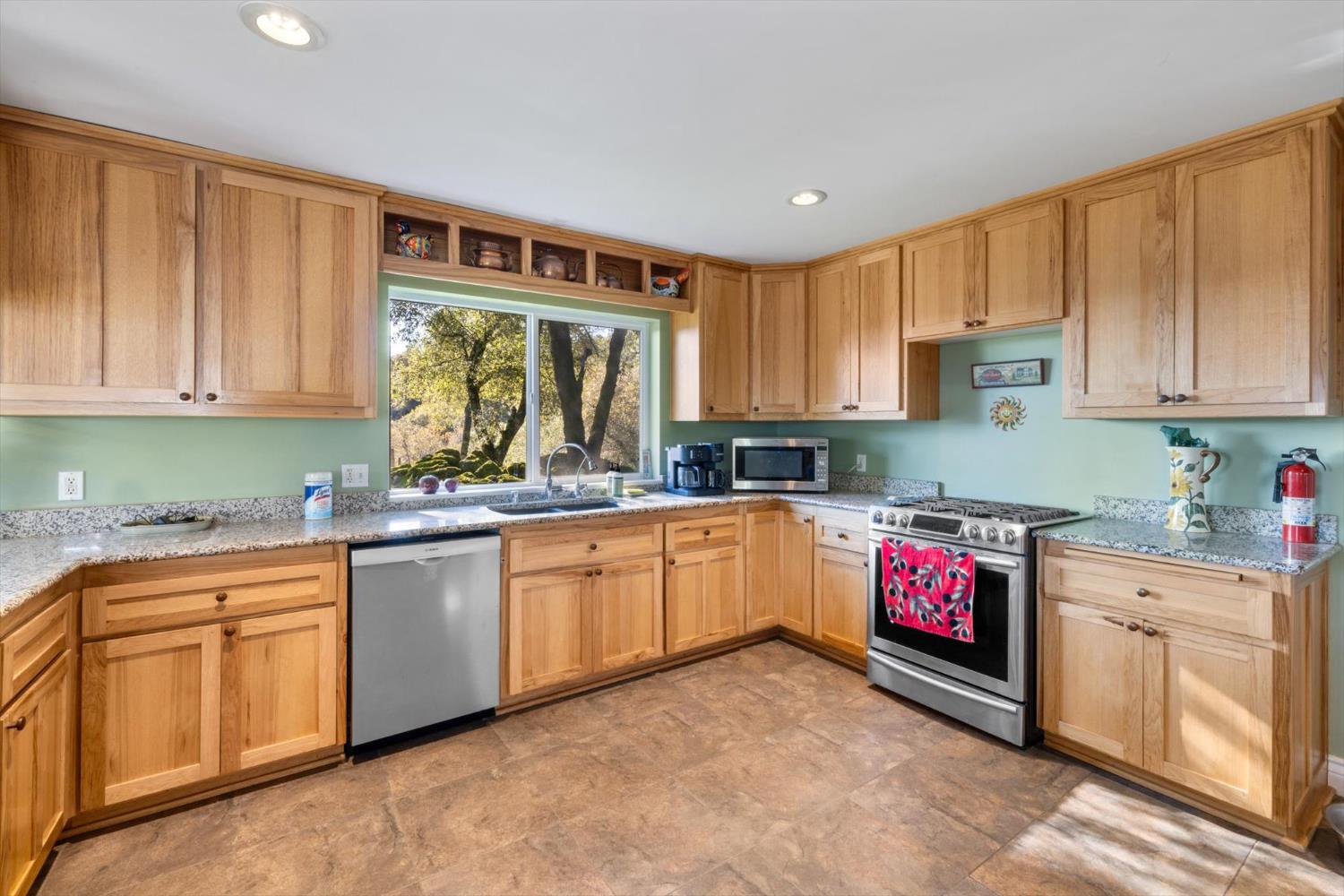 2870 Sand Ridge Road Placerville, CA 95667 - Photo 24 of 91 a kitchen with kitchen island granite countertop a stove sink and cabinets