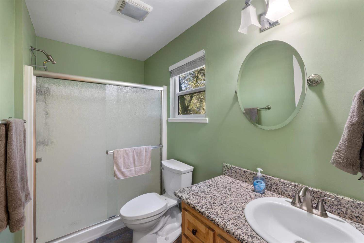 2870 Sand Ridge Road Placerville, CA 95667 - Photo 27 of 91 a bathroom with a granite countertop toilet a sink and a mirror