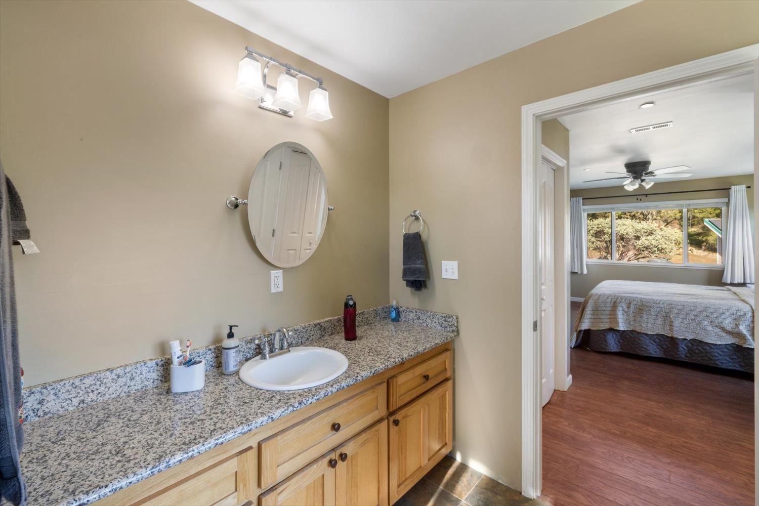 2870 Sand Ridge Road Placerville, CA 95667 - Photo 44 of 91 a en suite bathroom with a granite countertop double vanity sink and a mirror