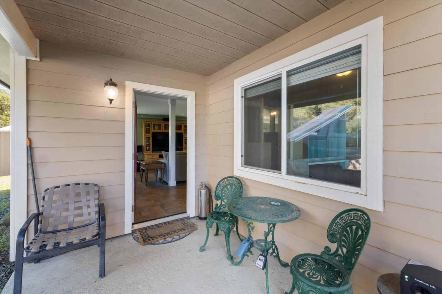 2870 Sand Ridge Road Placerville, CA 95667 - Photo 9 of 91 a front view of a house with outdoor seating and a potted plant